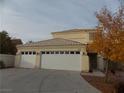 Two-story house with a three-car garage and autumn-colored trees at 2662 Churchill Cir, Henderson, NV 89074