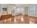 Bright living room with hardwood floors and a split-level layout at 295 Blackstone River Ave, Las Vegas, NV 89148