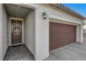 Two-car garage with a walkway to the front door at 5805 Vibrant Violet Ct, Las Vegas, NV 89130