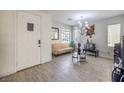 Living room with light wood floors, beige couch, and chandelier at 6228 Wood Stork Ave, Las Vegas, NV 89122