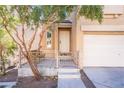 Small front yard with trees, a fence, and a patio at 6641 Hurkling Stone Ave, Las Vegas, NV 89139