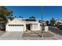 Single-story house with solar panels and a well-maintained front yard at 7608 Sea Wind Dr, Las Vegas, NV 89128