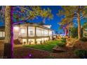 Backyard view featuring a covered patio and lush landscaping at 7880 Dana Point Ct, Las Vegas, NV 89117