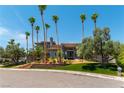 Two-story luxury home with a circular driveway and palm trees at 7880 Dana Point Ct, Las Vegas, NV 89117