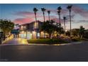 Luxury home at night with a modern garage and landscape lighting at 7880 Dana Point Ct, Las Vegas, NV 89117