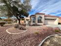 One-story home with desert landscaping, a gated entry, and a two-car garage at 8116 Sedona Sunset Dr, Las Vegas, NV 89128