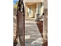 Front entry with a decorative gate and a tiled walkway leading to the door at 8116 Sedona Sunset Dr, Las Vegas, NV 89128