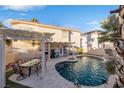 Relaxing backyard with a large pool, patio furniture, and pergola at 8529 Copper Knoll Ave, Las Vegas, NV 89129