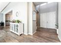 Bright entryway with white cabinets, hardwood floors, and double doors at 8595 Old Daylily Ln, Las Vegas, NV 89113