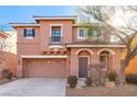 Two-story house with tan exterior, attached garage, and landscaping at 8809 Early Horizon Dr, Las Vegas, NV 89178