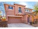 Two-story house with tan exterior, attached garage, and landscaping at 8809 Early Horizon Dr, Las Vegas, NV 89178