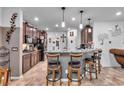 Spacious kitchen with dark cabinetry, granite counters, and island with seating at 8862 Nannette Marie Ct, Las Vegas, NV 89148