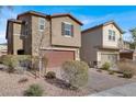 Two story house with a brown garage door and walkway at 9202 Valley Betica Ave, Las Vegas, NV 89148