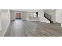 Spacious living room with grey wood-look floors at 9202 Valley Betica Ave, Las Vegas, NV 89148