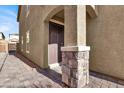 Side entrance with stone pillars and paved walkway at 9202 Valley Betica Ave, Las Vegas, NV 89148