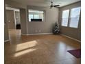 Spacious living room with tile floors and lots of natural light at 10046 Dancing Lasso Ct, Las Vegas, NV 89178