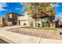 Stylish house with a beautifully landscaped yard and a modern facade at 10226 Jade Gardens Dr, Las Vegas, NV 89135