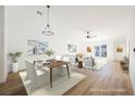 Bright dining room with hardwood floors and virtually staged furniture at 10229 Birch Bluff Ln, Las Vegas, NV 89145