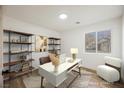 Virtually staged home office features built-in shelving and a modern desk at 10229 Birch Bluff Ln, Las Vegas, NV 89145