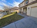 Front view of two-story house with landscaping and driveway at 1113 Dawn Valley Dr, North Las Vegas, NV 89031