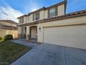 Two-story house with attached garage and landscaping at 1113 Dawn Valley Dr, North Las Vegas, NV 89031