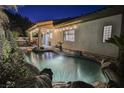 Inviting freeform pool with waterfall feature and landscaped surroundings at 140 Cora Hills Ct, Las Vegas, NV 89148