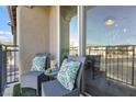 Relaxing balcony features two chairs and a small table at 20 Red Oak Canyon St # 3, Henderson, NV 89012