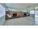 Living room with brick fireplace and mirrored walls at 2108 Kirk Ave, Las Vegas, NV 89101