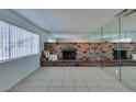 Living room with brick fireplace and mirrored wall at 2108 Kirk Ave, Las Vegas, NV 89101