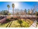 Neatly landscaped grassy area with trees and walkway at 2300 Silverado Ranch Blvd # 1070, Las Vegas, NV 89183