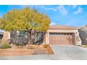 Single-story home with a two-car garage and a large front yard at 2568 Dirleton Pl, Henderson, NV 89044