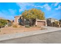 Single-story house with a brown garage door and a landscaped front yard at 2568 Dirleton Pl, Henderson, NV 89044