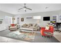 Spacious living room with beige sofa and orange accent chair at 2736 Mintlaw Ave, Henderson, NV 89044