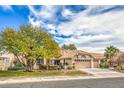 Single-story house with a large front yard and driveway at 3128 Pelican Beach Dr, Las Vegas, NV 89117