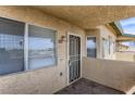 Private condo entry with security door and blinds at 332 S Buffalo Dr # 202, Las Vegas, NV 89145