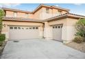 Two-story house with beige exterior, two-car garage, and landscaping at 3748 Honey Crest Dr, Las Vegas, NV 89135