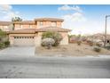 Two-story house with beige exterior, two-car garage, and landscaping at 3748 Honey Crest Dr, Las Vegas, NV 89135