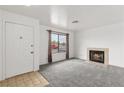 Living room with a fireplace, grey carpet, and a view of the front yard at 392 Dooley Dr, Henderson, NV 89015