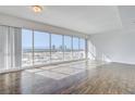 Bright living room with hardwood floors and stunning city views at 4575 Dean Martin Dr # 1108, Las Vegas, NV 89103