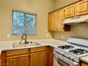 Small kitchen with light wood cabinets, white appliances, and a gas stove at 5650 E Sahara Ave # 2029, Las Vegas, NV 89142