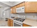 Modern kitchen with light wood cabinets and gas stove at 5728 Palma Del Sol Way, Las Vegas, NV 89130