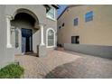 Brick paved walkway to the front entrance with columns and a dark door at 5892 Rothbury Ave, Las Vegas, NV 89141