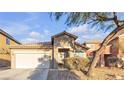 Single-story house with a beige exterior and attached garage at 6452 Casamar St, North Las Vegas, NV 89086