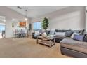 Spacious living room with a sectional sofa and built-in shelving at 6452 Casamar St, North Las Vegas, NV 89086