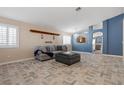 Spacious living room featuring a neutral color palette, tiled floors, and comfortable seating at 6501 Grand Oaks Dr, Las Vegas, NV 89156