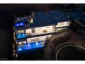 Night view of a contemporary home showcasing a multi-tiered pool at 665 Overlook Rim Dr, Henderson, NV 89012