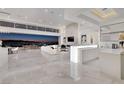 Open-concept living room with marble floors, a fireplace, and floor-to-ceiling windows overlooking the city at 665 Overlook Rim Dr, Henderson, NV 89012