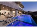 Luxury pool area with waterfall feature, lounge chairs, and modern gym overlooking mountain views at 665 Overlook Rim Dr, Henderson, NV 89012