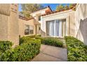 Neatly landscaped entryway with a walkway and hedges at 6908 Emerald Springs Ln, Las Vegas, NV 89113