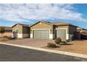 Single-story house with three-car garage and desert landscaping at 74 Wildcat Ave, Pahrump, NV 89060